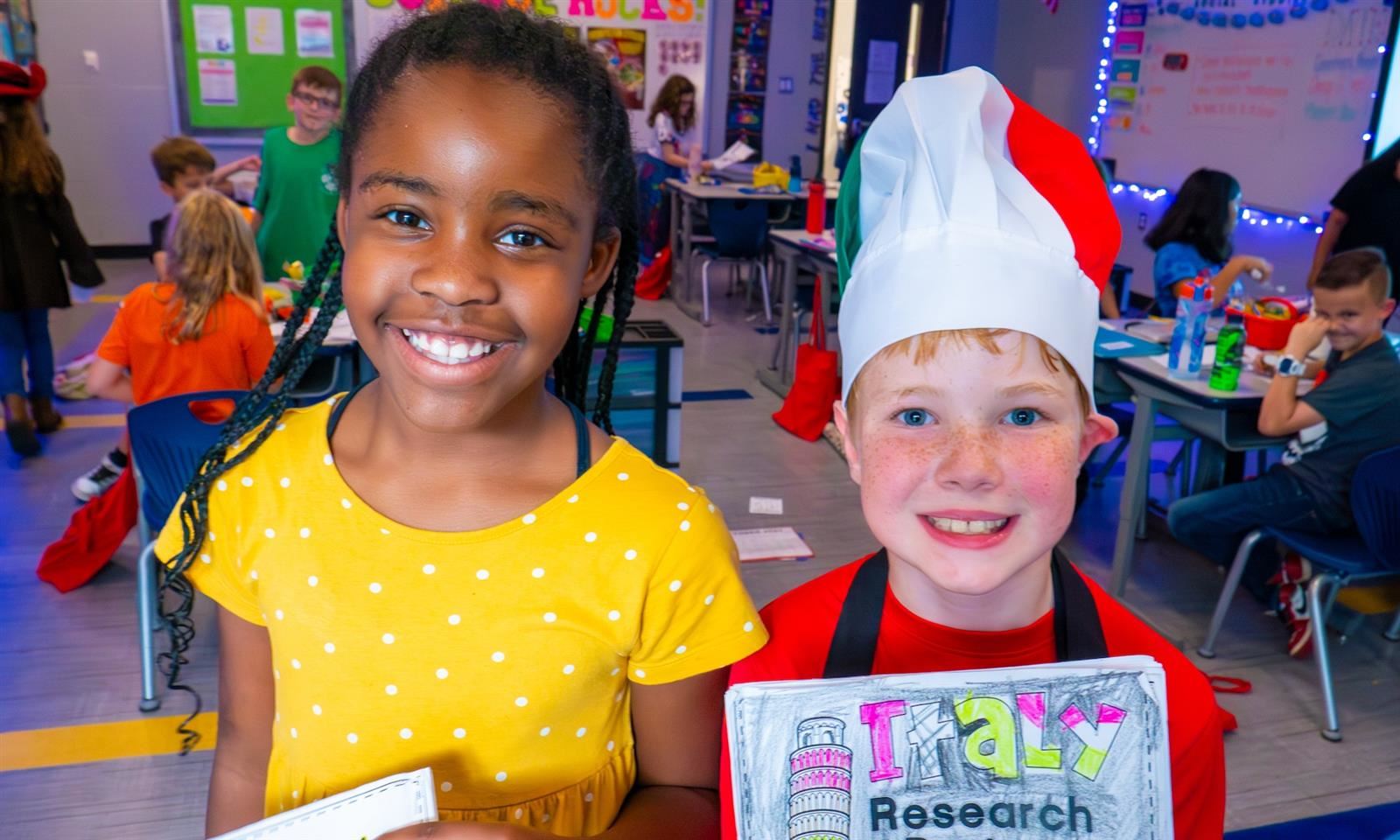 Two students smile